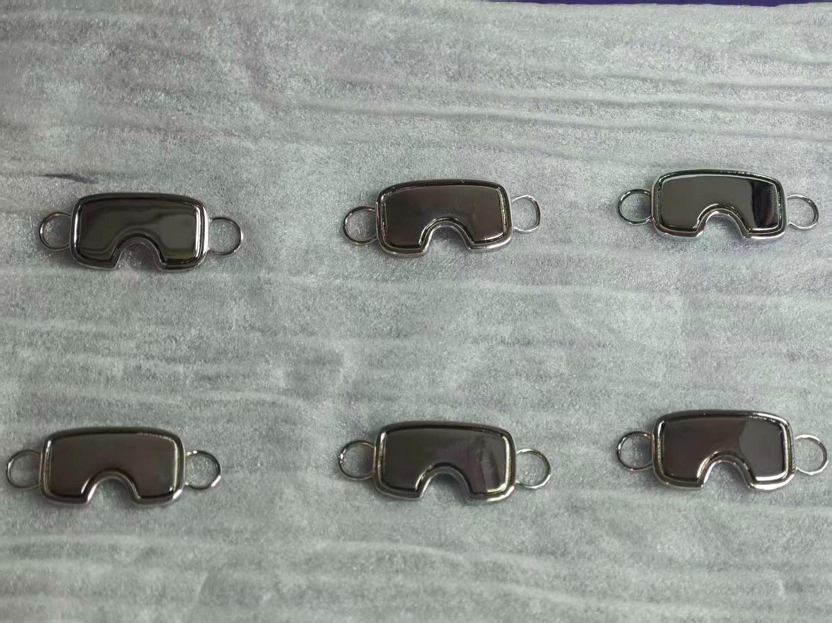 Six sample goggle charms from the workshop