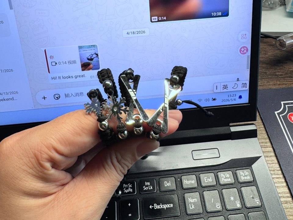 Sample bracelets in hand, WhatsApp chat with the workshop on screen
